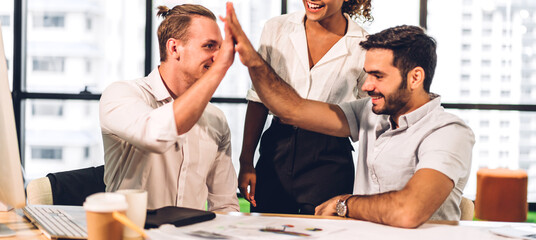 Successful of group professional business people to win of celebrating project success.Creative business happy and enjoy gesture hand high five good teamwork together at green plant terrace workloft