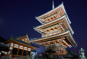 The illuminated three-storied pagoda and Sutra hall at night. Kiyomizu-dera temple. Kyoto. Japan