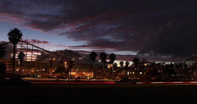 Time-lapse of a sunset over a rollercoaster/amusement park