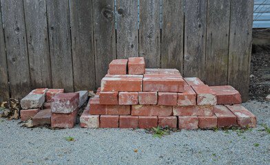 building materials are on floor, stack of red bricks