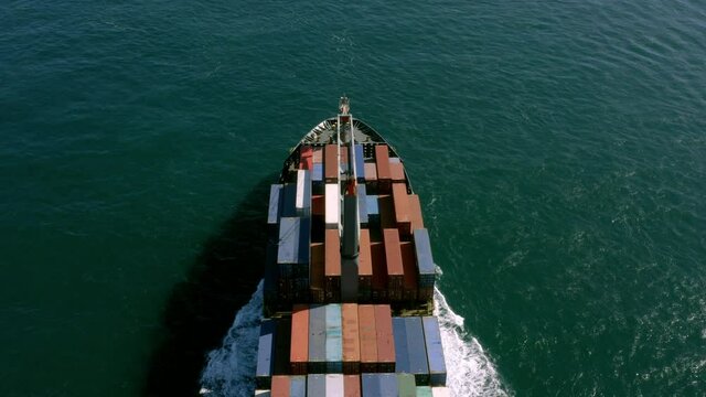 Cargo ship leaving port from aerial perspective