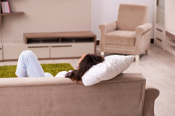 Young lazy man in oversleeping concept at home