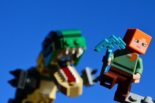 LEGO Minecraft figure of Alex running from angry Tyrannosaurus Rex from LEGO  Creator series, holding diamond pickaxe in left hand. Stock Photo | Adobe  Stock