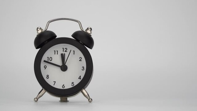 alarm clock on a white background. fast movement of the hour hands. minute hand of the clock at an accelerated pace
