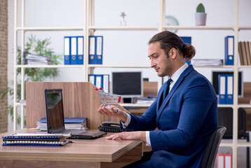 Young male employee in e-commerce concept