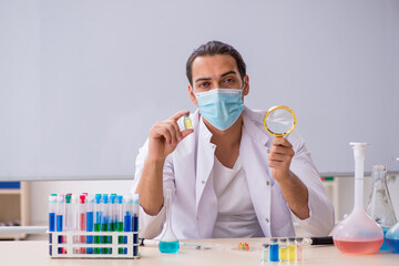 Young male chemist working in the lab