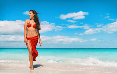 Beach bikini model in red swimsuit and skirt for wellness spa luxury. Hair removal laser treatment...