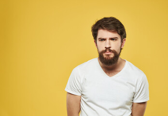 Portrait of handsome man yellow background beard brunette model