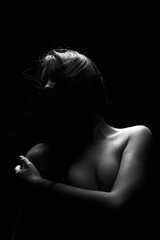 Fototapeta na wymiar Nude Woman silhouette in the dark