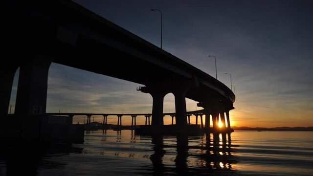 Time-lapse of a sunset over a bridge