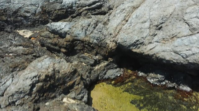 Tide pool and rocky reef with trash from ocean at Tsukazaki Tide Pools, Japan