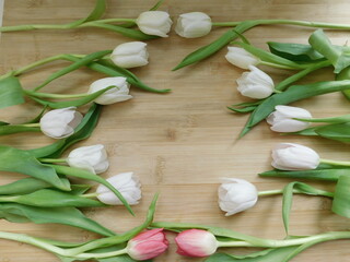 Colorful tulips over wooden background. Easter card with space for your greetings.