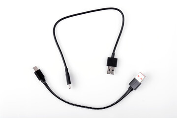Black USB cable with plugs type A and type C at the edges on a white background