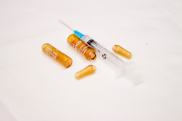 Empty medical ampoules infusion and used syringe after injection isolated on white background