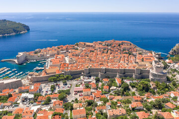 Aerial drone shot of City Walll Dubrovnik by Adriatic sea in Croatia summer noon