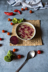 Healthy food ingredient chicken soup prepared with white oil and beetroot. Top view, selective focus