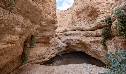Hard hiking trail in a remote part of Negev desert, Israel. Climbing and adrenaline. Ropes and ladders on a hiking trail.