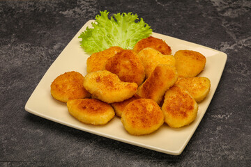 Fried chicken nuggets served salad leaves