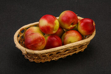 Sweet small nectarines in the basket