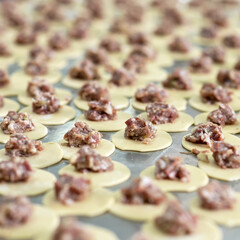 Process preparation of Dumplings with meat filling. Meal cooking of Convenient food. Abstract background. Square format or 1x1 for posting on social media. Soft focus.