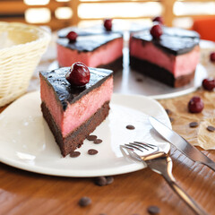 Cherry on piece of chocolate cake. Sweet gift or present for beloved person or woman. Holiday or festive mood concept. Exquisite goodiesfor refined taste.
