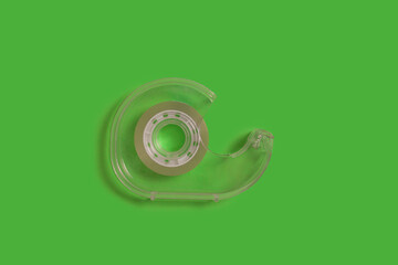 scotch tape dispenser isolated on a green background