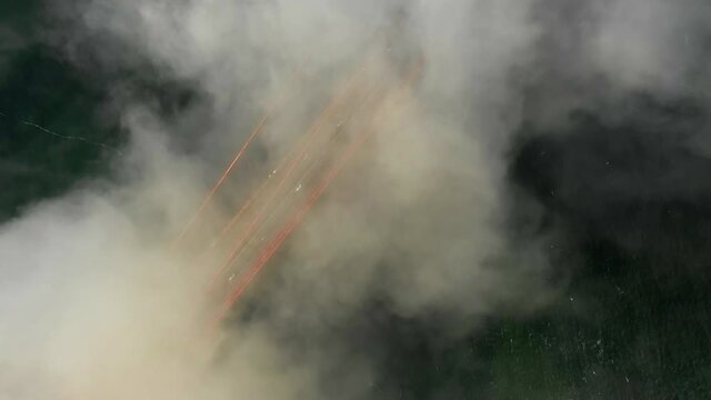 Aerial shot of vehicles on famous bridge over bay under foggy weather, drone circling over Golden Gate Bridge - San Francisco, California