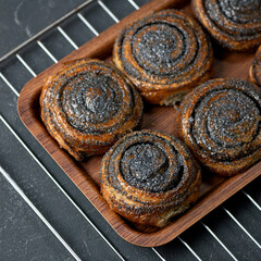 Sweet buns with poppy seeds fresh from the oven. Pastries, dessert Food. Delicious morning concept. Square format or 1x1 for posting on social media.