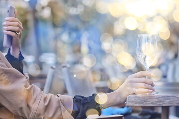 white wine glass in an outdoor cafe, spring view in a restaurant
