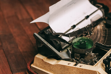 Fototapeta na wymiar vintage typewriter for printing white sheet of paper wooden background retro invention