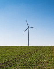 A closeup shot of a road leading to the windmill on the land