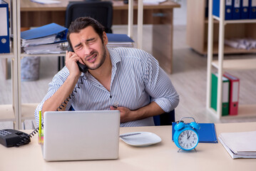 Hungry male employee waiting for food in time management concept