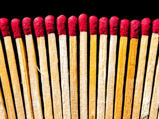 Wooden matches with red sulfur heads on a black background. Fire ignition matches. Matchbox. Red...