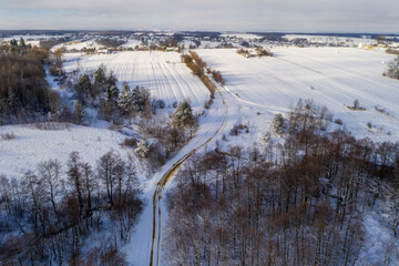 Winter landscape of forest and fields, snowy fields and trees in the forest.