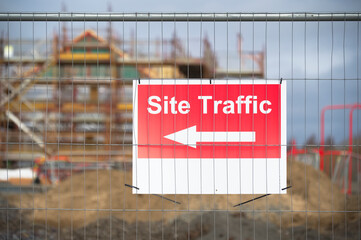 Site traffic direction sign at construction site entrance