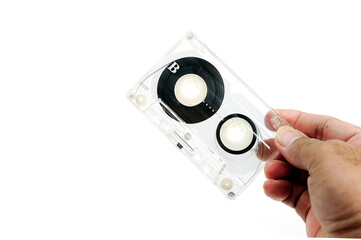 Fototapeta premium Hand holding cassette tape isolated on white background. Old cassette tape audio isolated on white. 