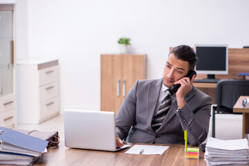 Naklejka premium Young male employee working in the office