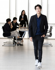 An executive look tomboy woman in casual suit walking in office with smart and confident gesture