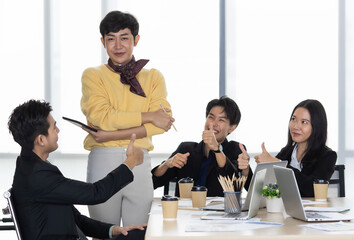 A group of multi sex colleagues, tomboy, transgender and lesbian businesspeople working together...