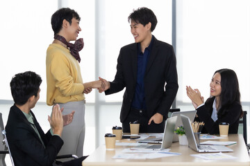 A group of multi sex colleagues, tomboy, transgender and lesbian businesspeople working together...
