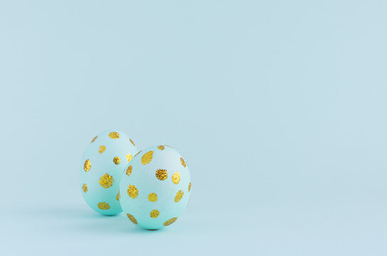 Elegant Easter Eggs With Gold Dots On Blue Background, Copy Space.