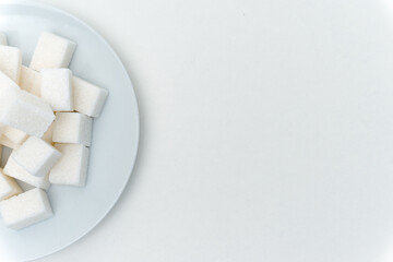 refined sugar sweets calories on a plate light background