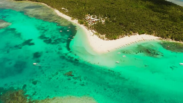 Seascape with beautiful beach and tropical island palm trees by coral reef from above. Daco island, Philippines. Summer and travel vacation concept