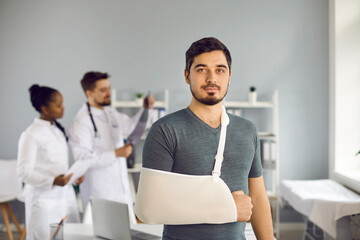 Medicine, healthcare and traumatology. Portrait of caucasian man having arm sling bandage on broken...
