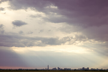 City skyline at sunset under the stormy skies.