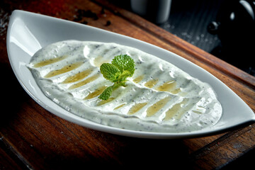 Haydari is a type of yogurt made from certain herbs and spices, combined with garlic. Turkish cuisine. Close up, selective focus