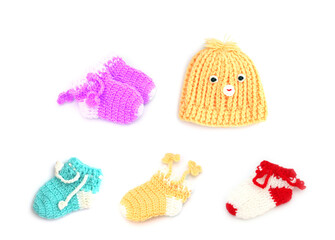 Handmade sweet baby boots and hat isolated on white background