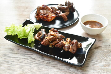 roasted pork neck and innards on plate dipping with tamarind sauce