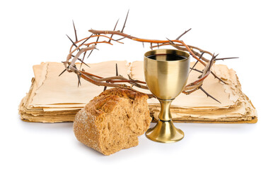 Holy Bible with chalice of wine, bread and crown of thorns on white background