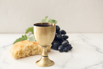 Chalice of wine and bread on white background